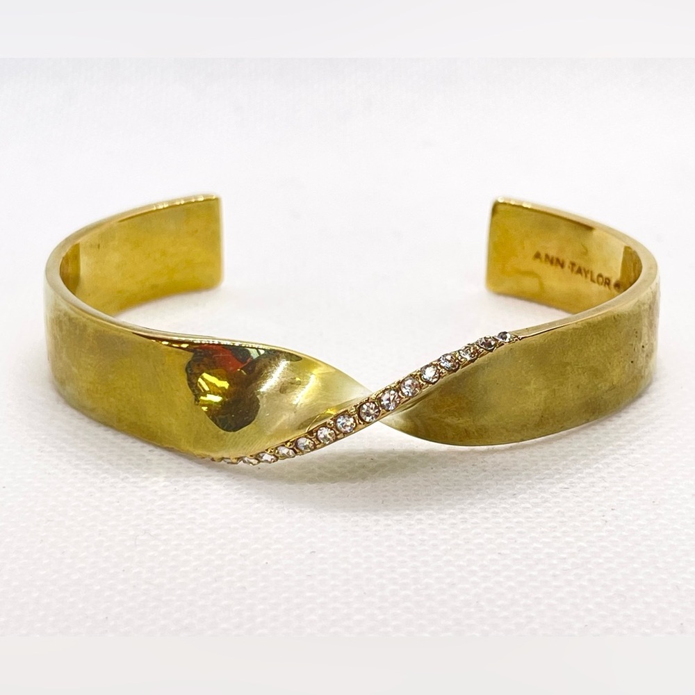 Anne Taylor gold tone bangle with rhinestone accents and “twist” detail!